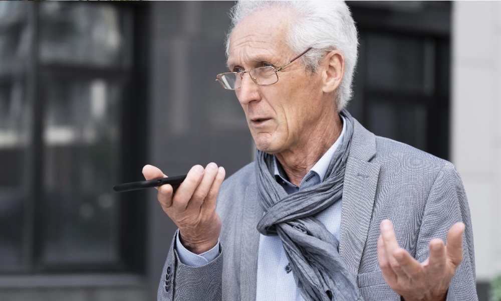 senior male using voice search on his phone