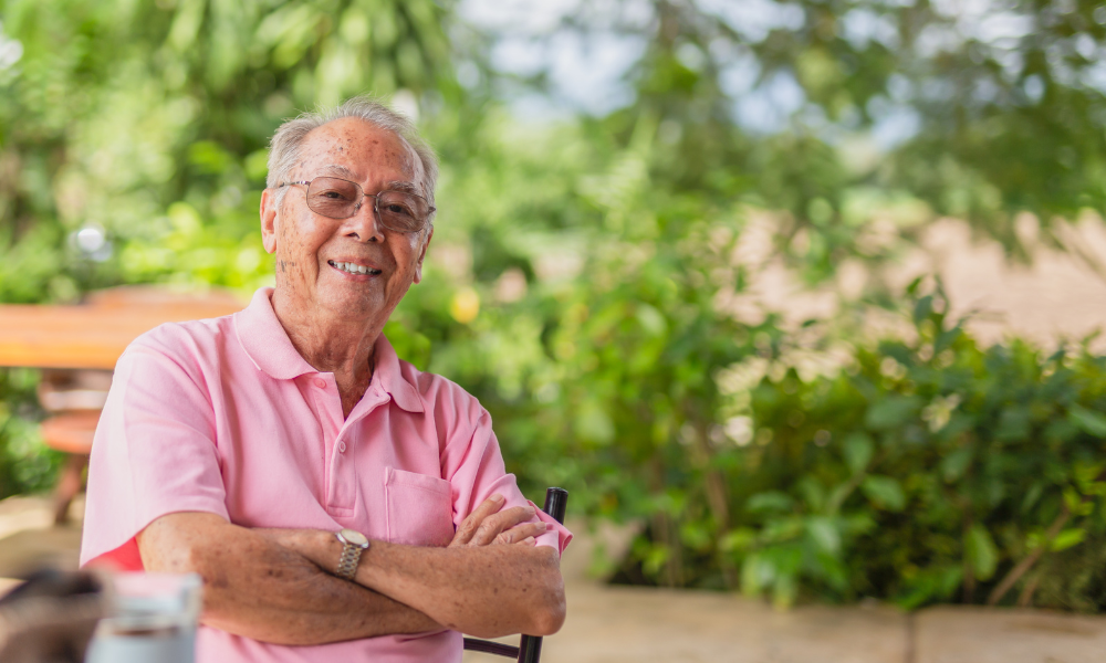 Elderly Asian man smiling at the camera