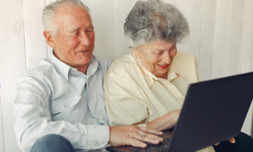 Senior husband and wife checking out content on a laptop