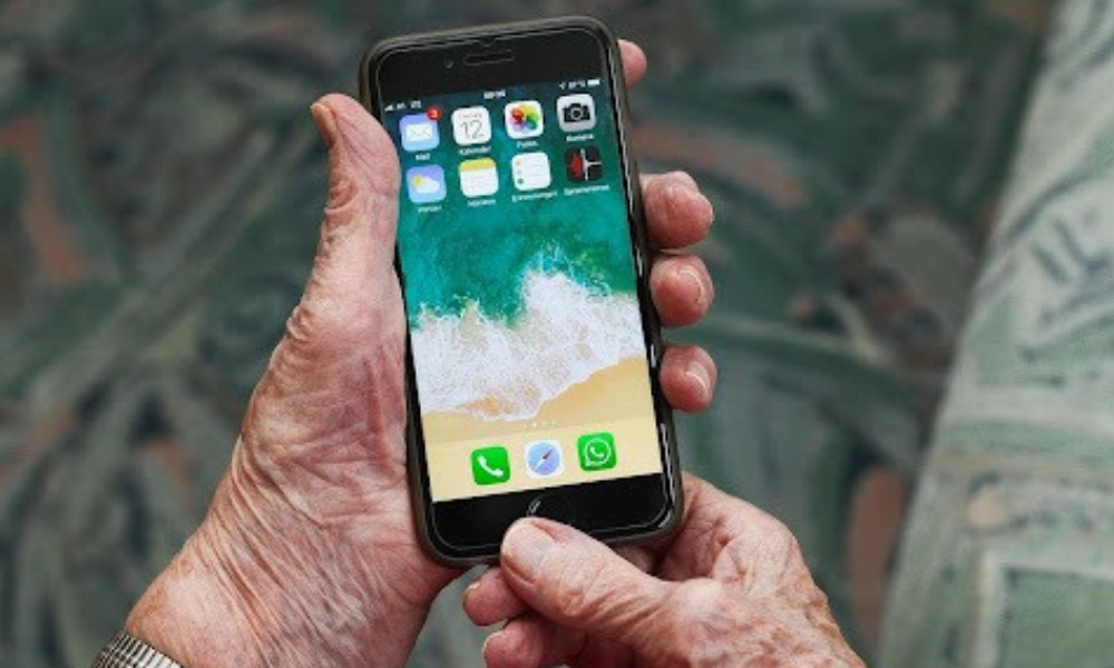 Elderly person holding a phone