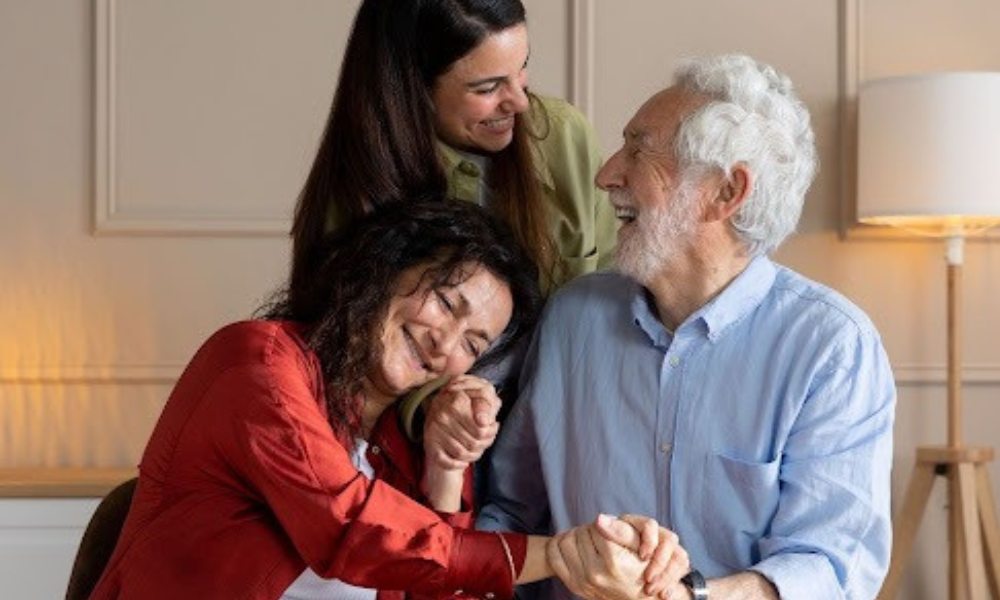 Family embracing their elderly family member